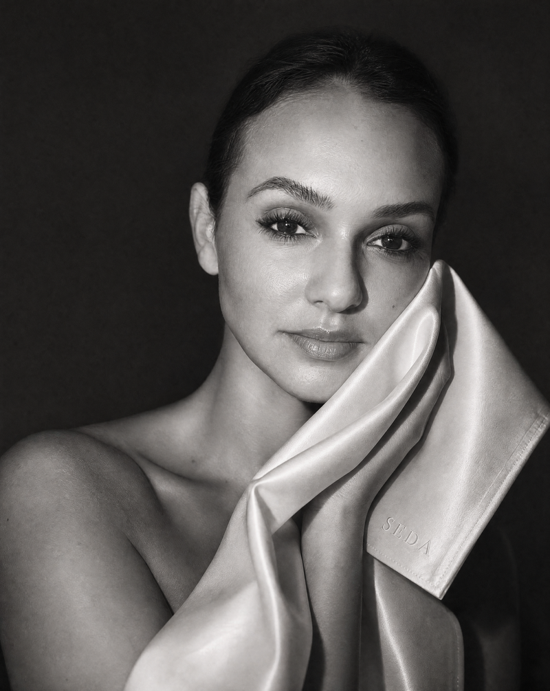 A champagne SEDA silk face cloth being pressed gently against the face after cleansing